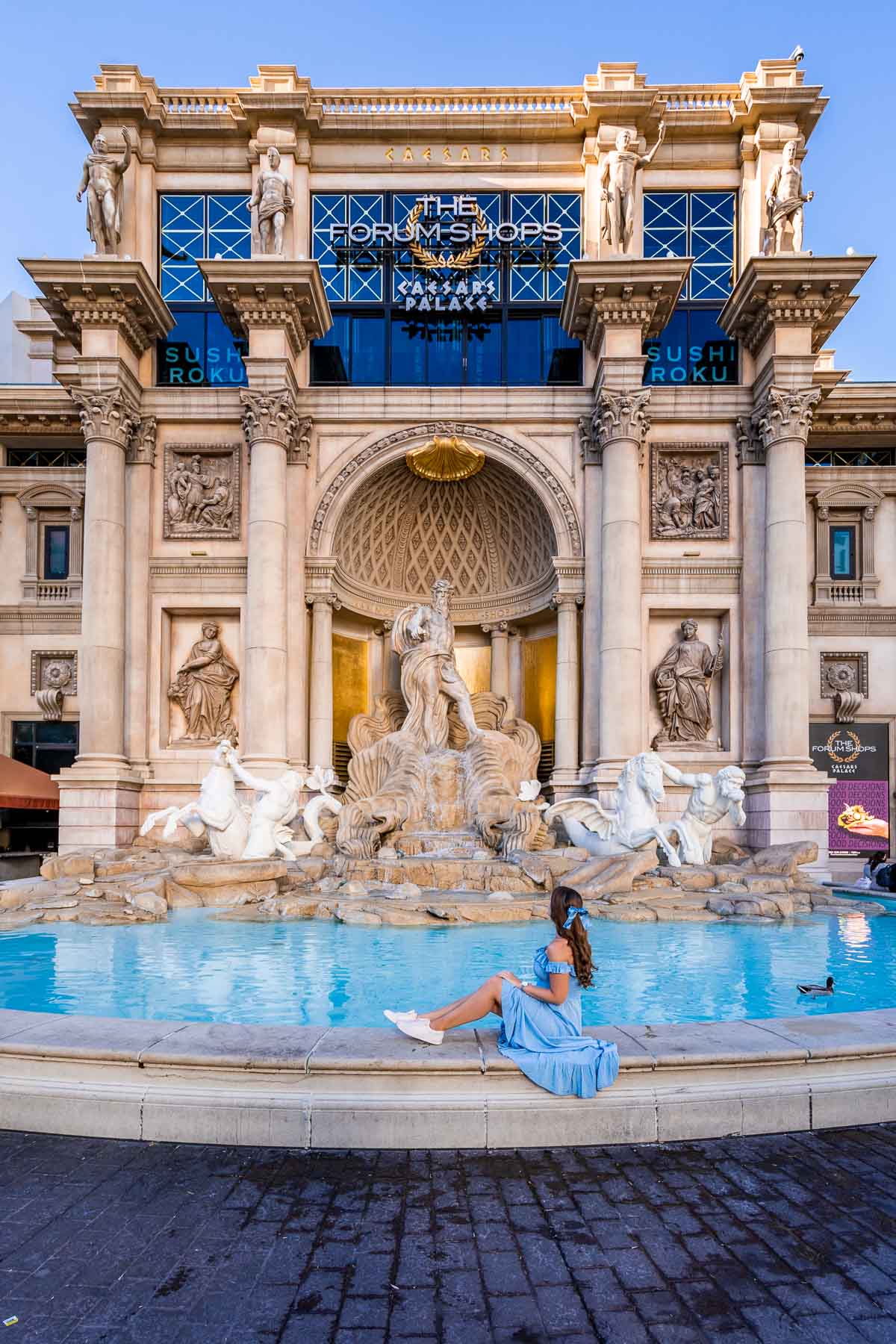 Girl in blue dress in front of the Trevi Fountain at Caesar's Palace in Las Vegas