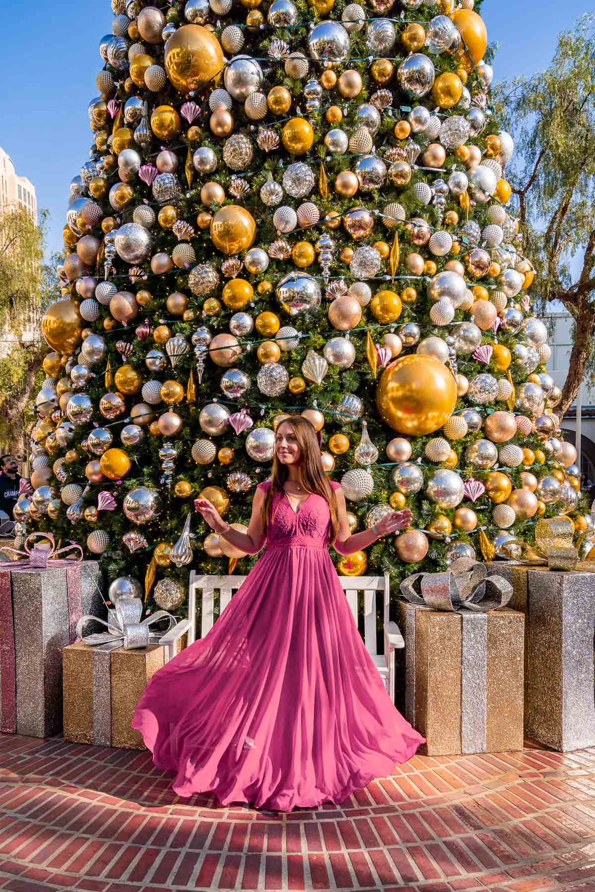 Girl in pink dress in front of the Christmas tree in Union Square in Los Angeles