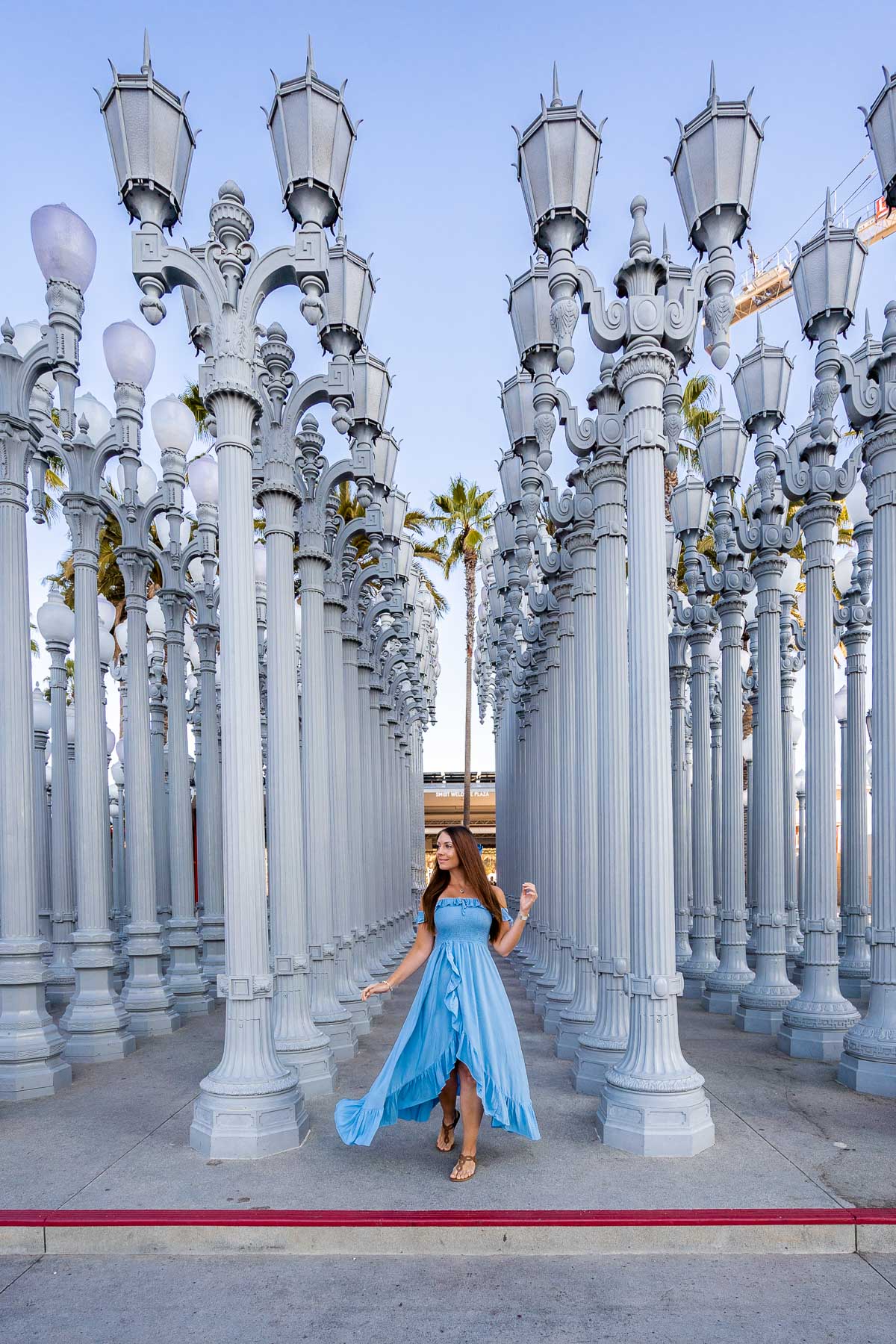 Girl in blue dress in front of the Urban Lights at LACMA