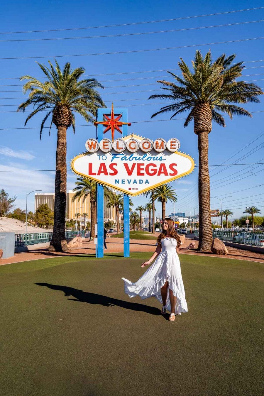 Girl in white dress in front of the Welcome to Las Vegas Sign, one of the best Las Vegas Instagram Spots