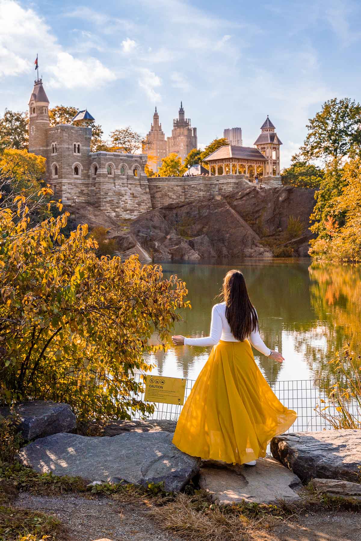 Girl in yellow dress in front of the Belvedere Castle in Central Park, New York