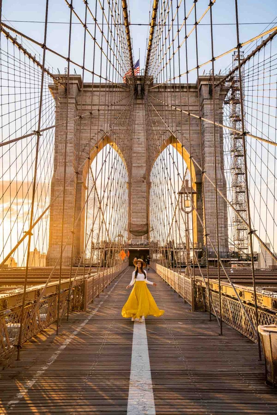 Girl in yellow skirt on Brooklyn Bridge in New York
