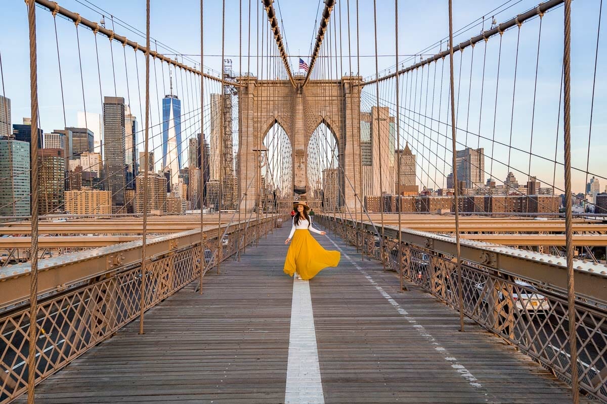 Girl in yellow skirt on the Brooklyn Bridge in New York