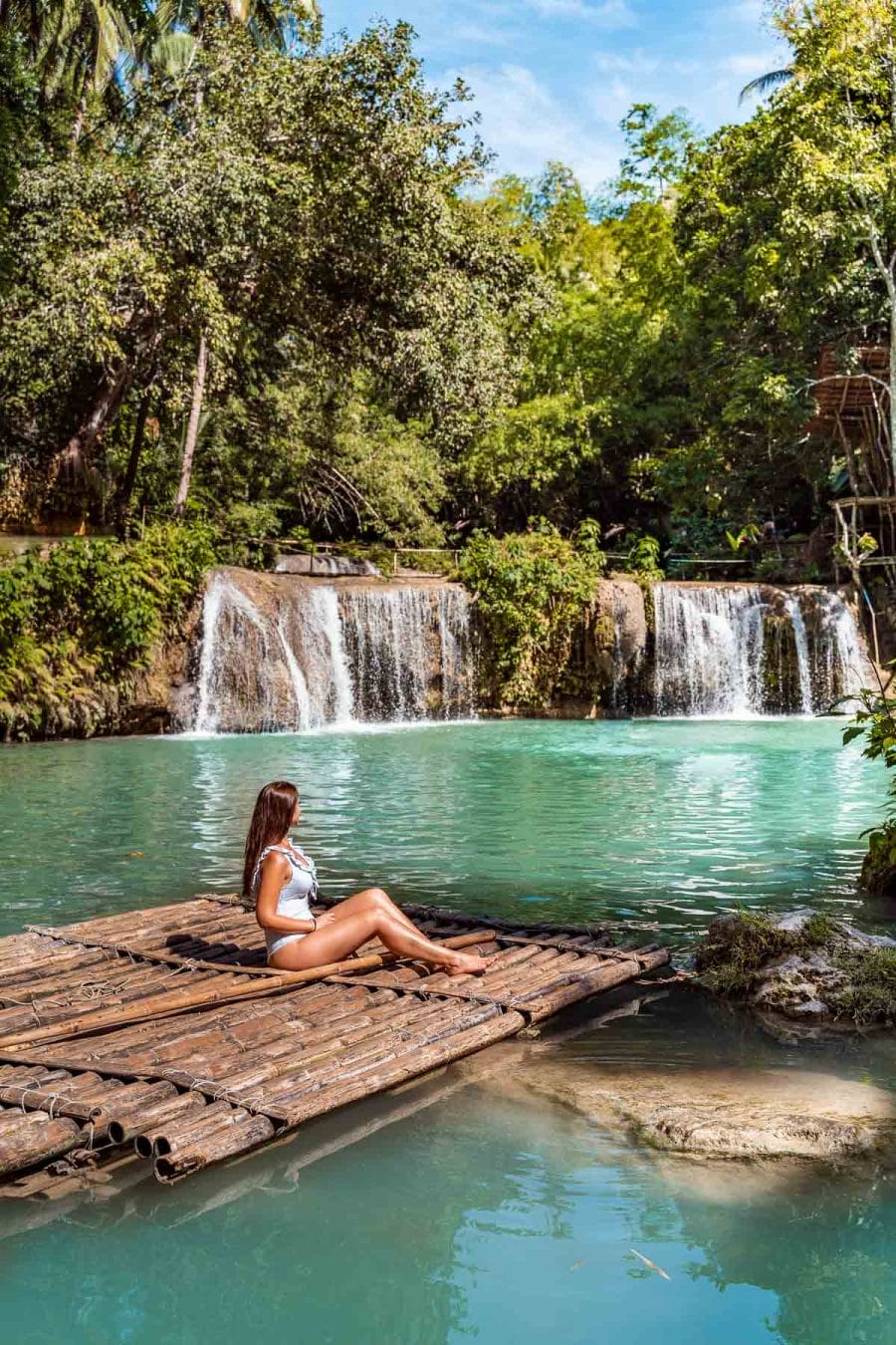 Girl sitting on a raft boat at Cambugahay Falls in Siquijor, Philippines