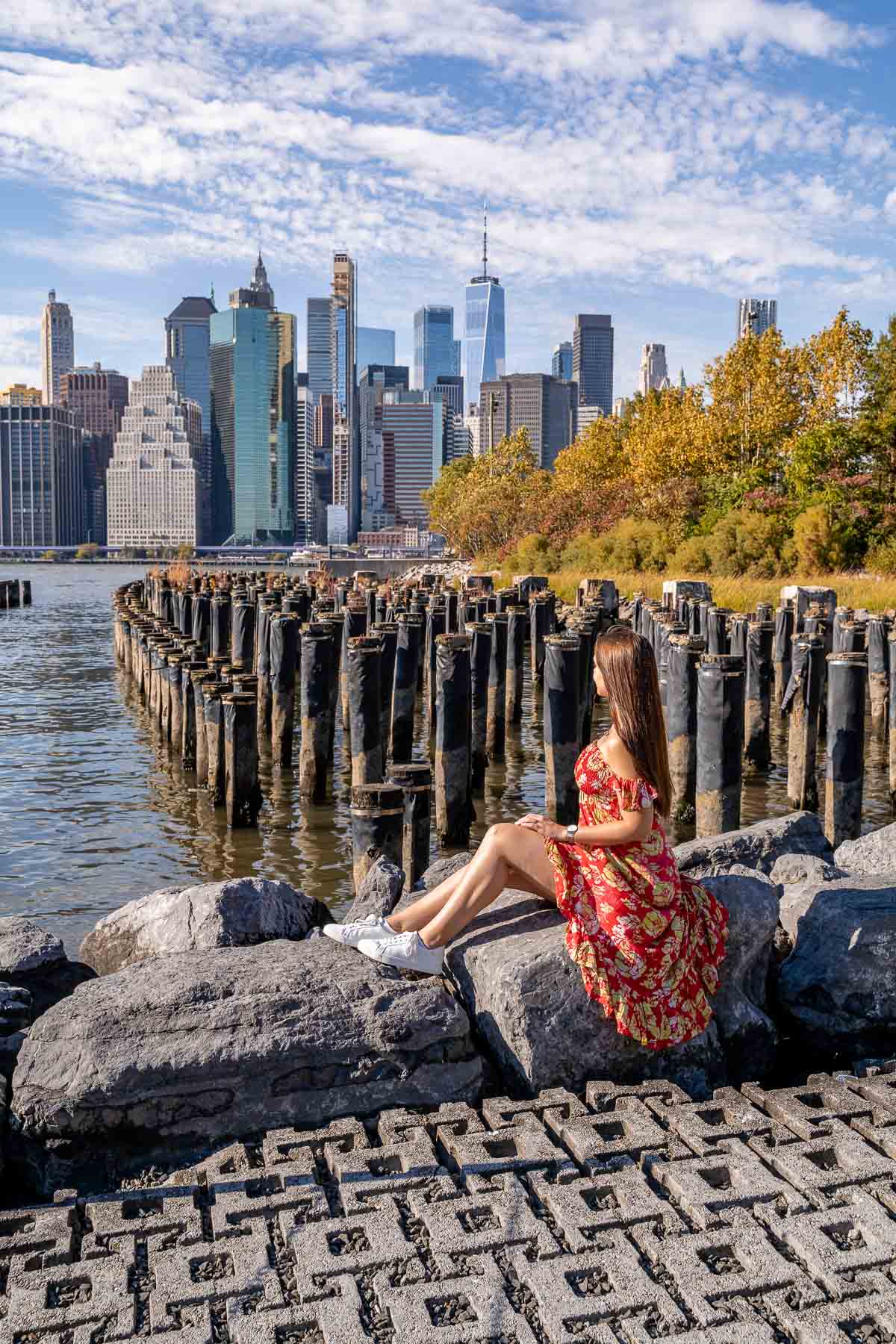 Girl in red dress sitting at Old Pier 1 at Brooklyn Bridge Park