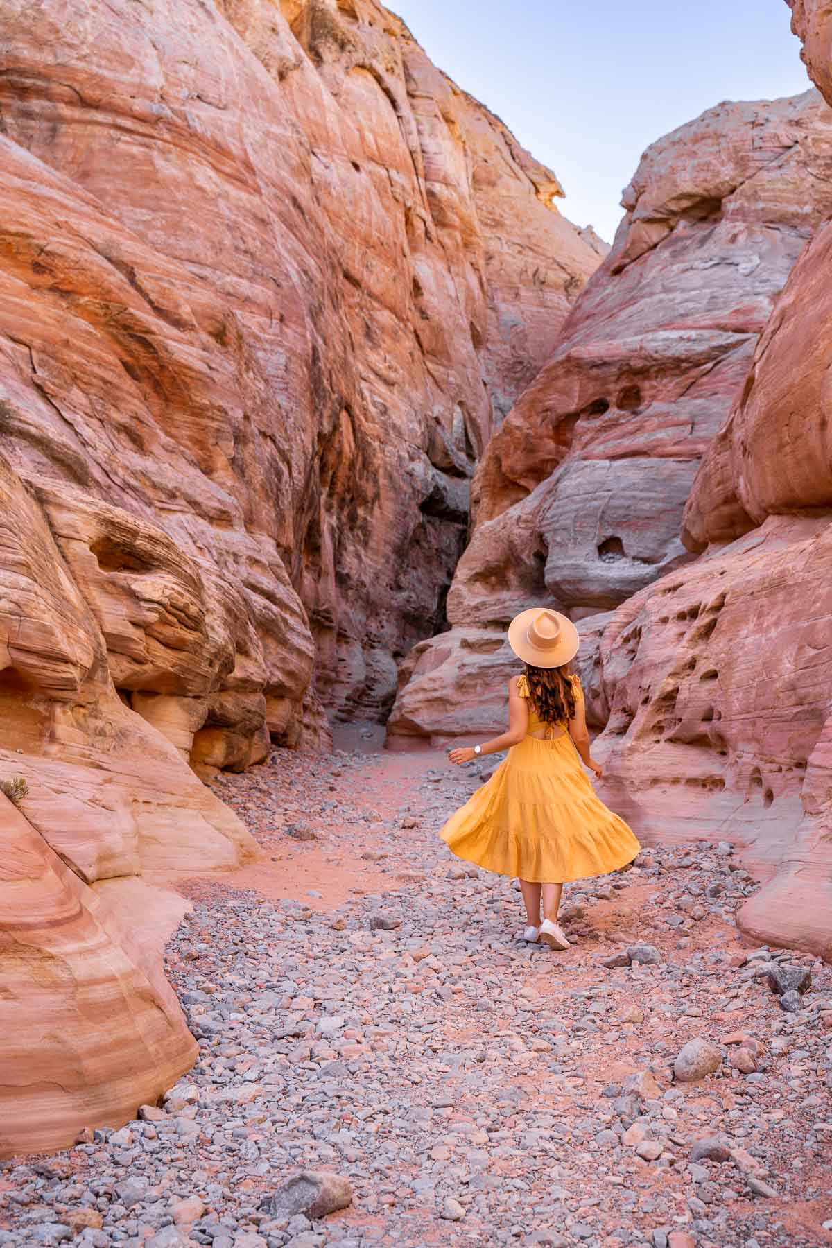 Girl in yellow dress at the Slot Canyon on the White Domes Trail