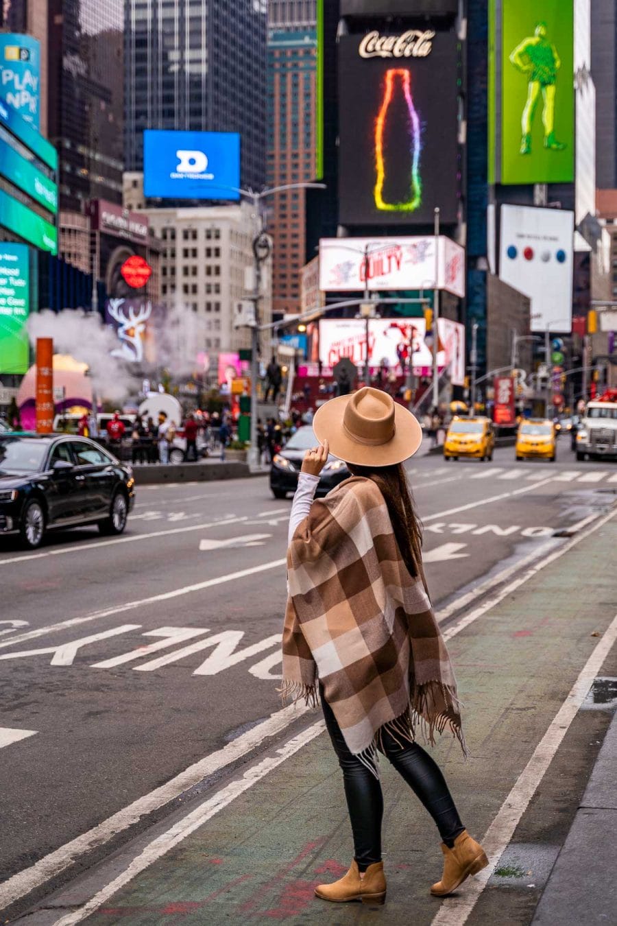 Girl standing at Times Square, one of the most Instagrammable places in NYC