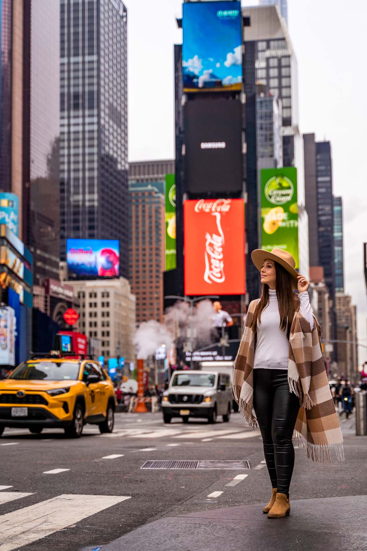 Girl standing at Times Square, one of the most Instagrammable places in NYC