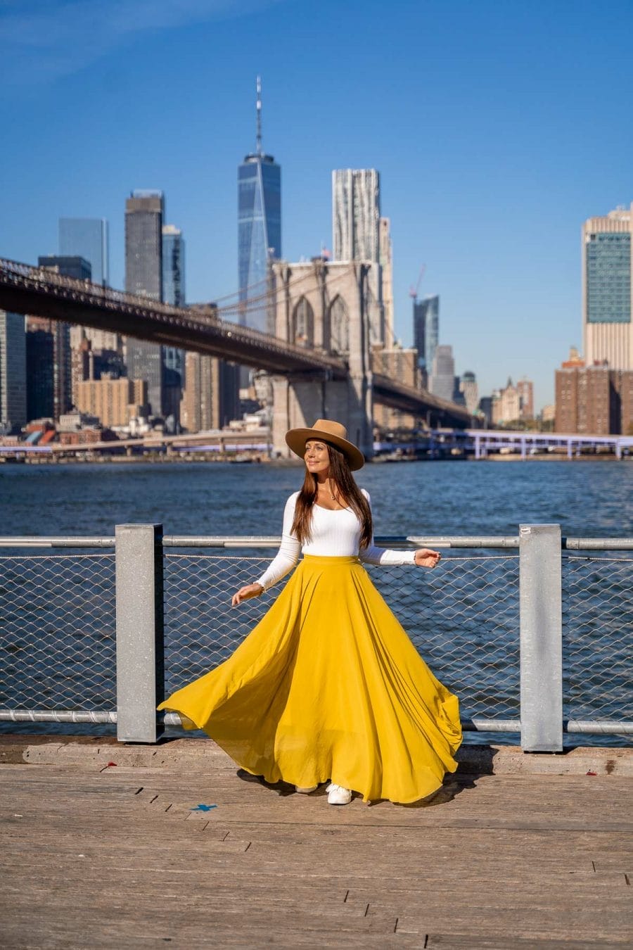 Girl in yellow skirt in front of the New York skyline at Jane's Carousel, Brooklyn