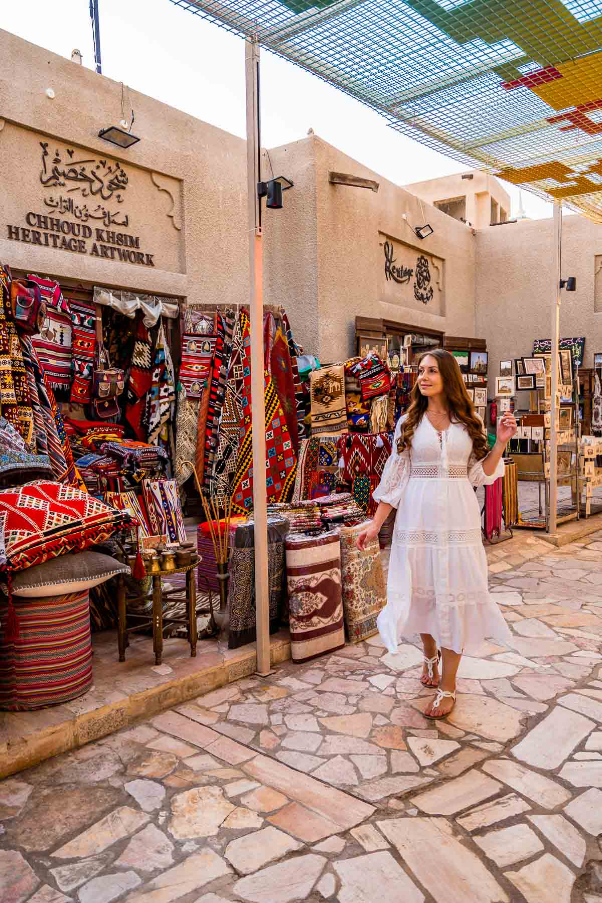 Girl in front of a carpet shop in Old Dubai