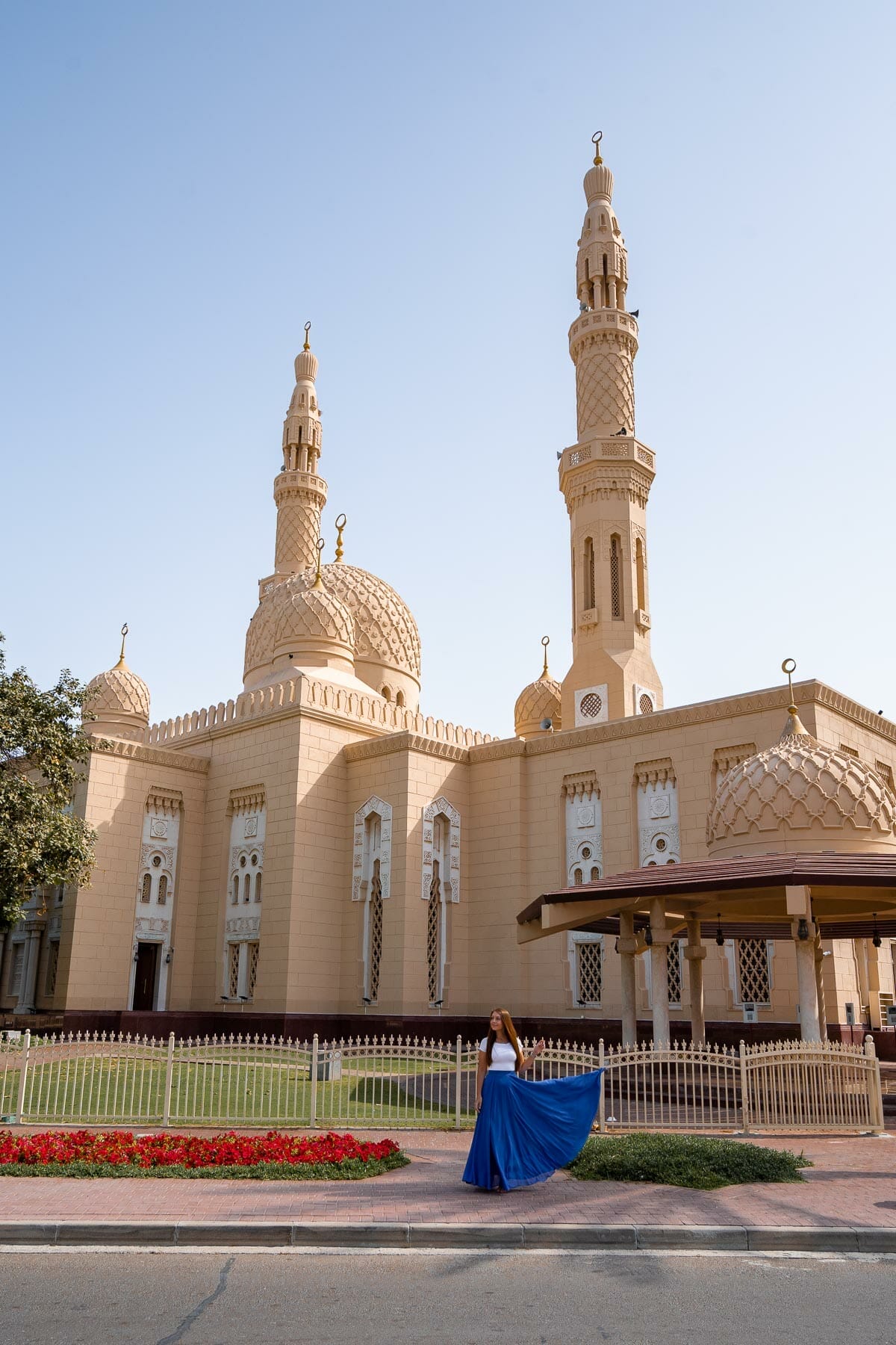 Girl in blue skirt in front of Jumeirah Mosque in Dubai