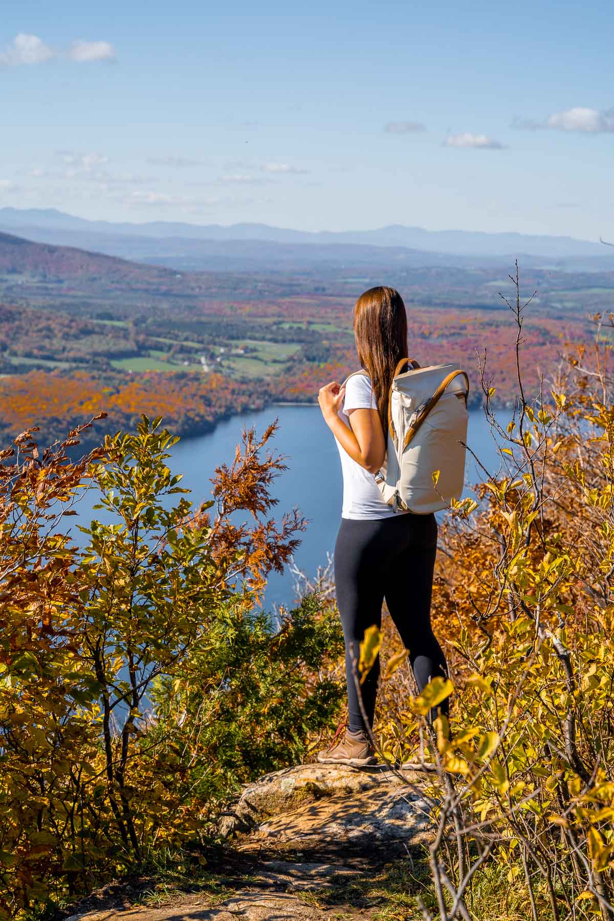 Girl on the top of Mount Pisgah, overlooking Lake Willoughby in Vermont in the fall