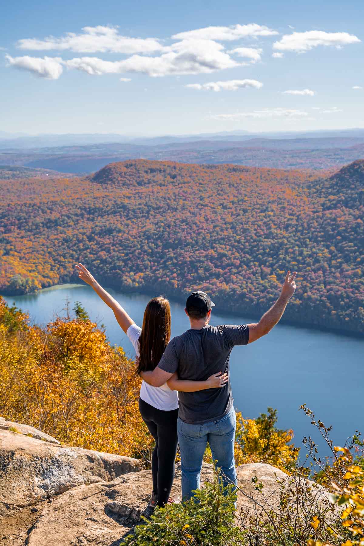 Girl and boy on the top of Mount Pisgah, overlooking Lake Willoughby in Vermont in the fall