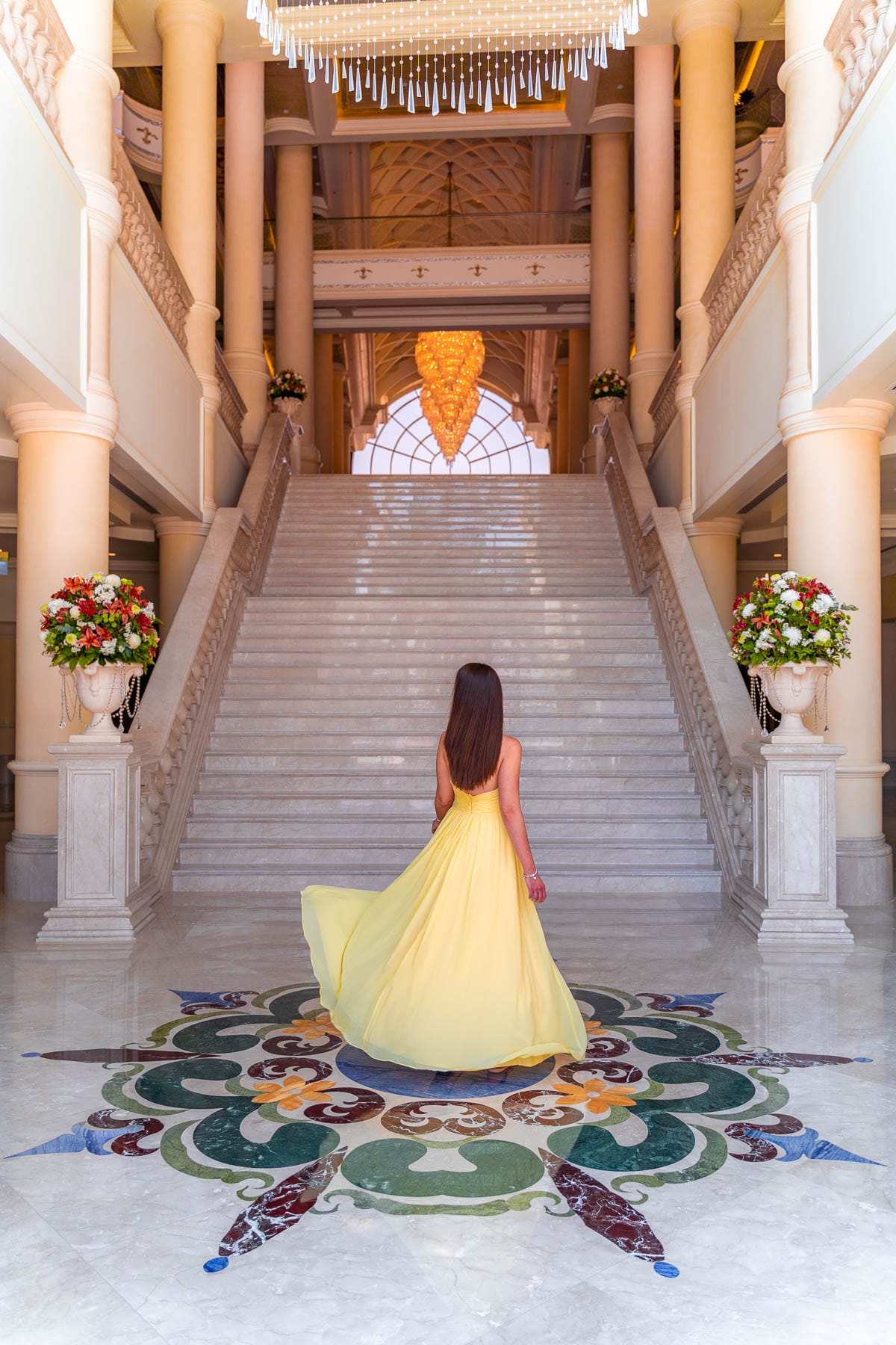 Girl in a yellow dress standing in the Lobby of the Ritz Carlton Abu Dhabi