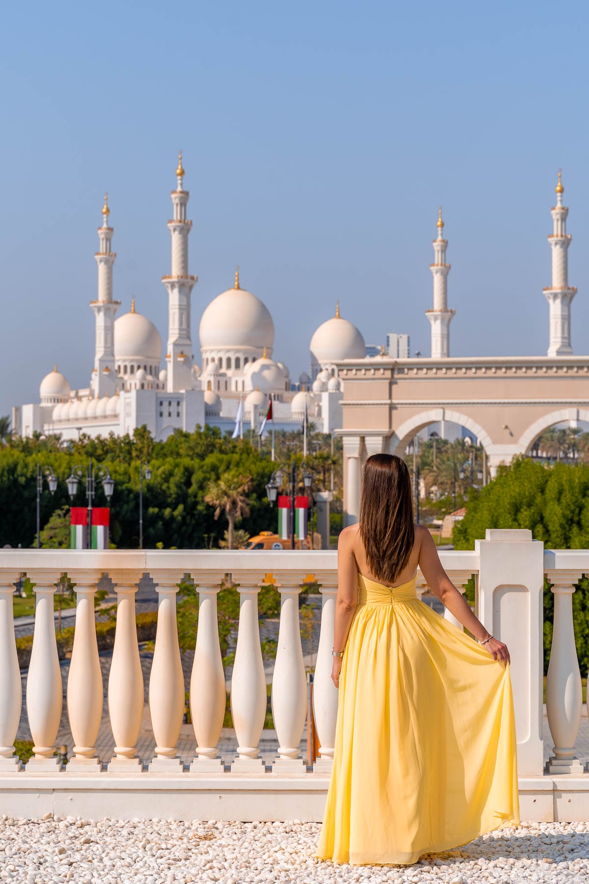 Girl in yellow dress at Ritz-Carlton Abu Dhabi overlooking Sheikh Zayed Grand Mosque