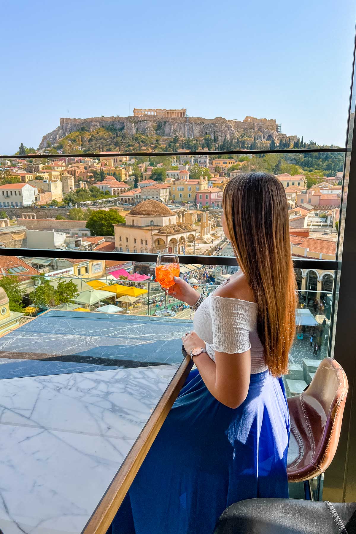 Girl sitting at A for Athens Rooftop Bar