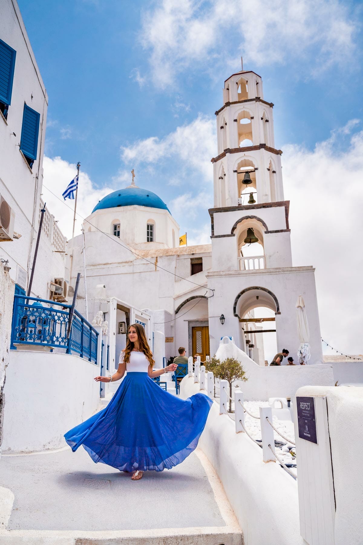 Girl in blue skirt in front of Agios Nikolaos Theotokaki in Pyrgos, Santorini