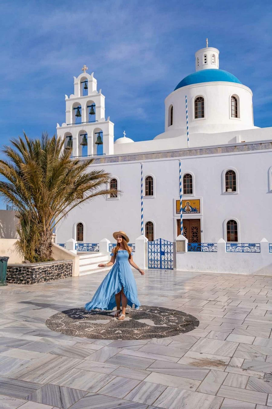 Girl in blue dress in front of Church of Panagia Akathistos Hymn in Oia, Santorini