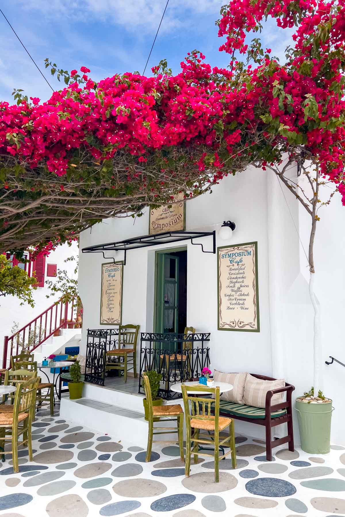 Outdoor terrace with pink flowers at Cafe Symposium Paros