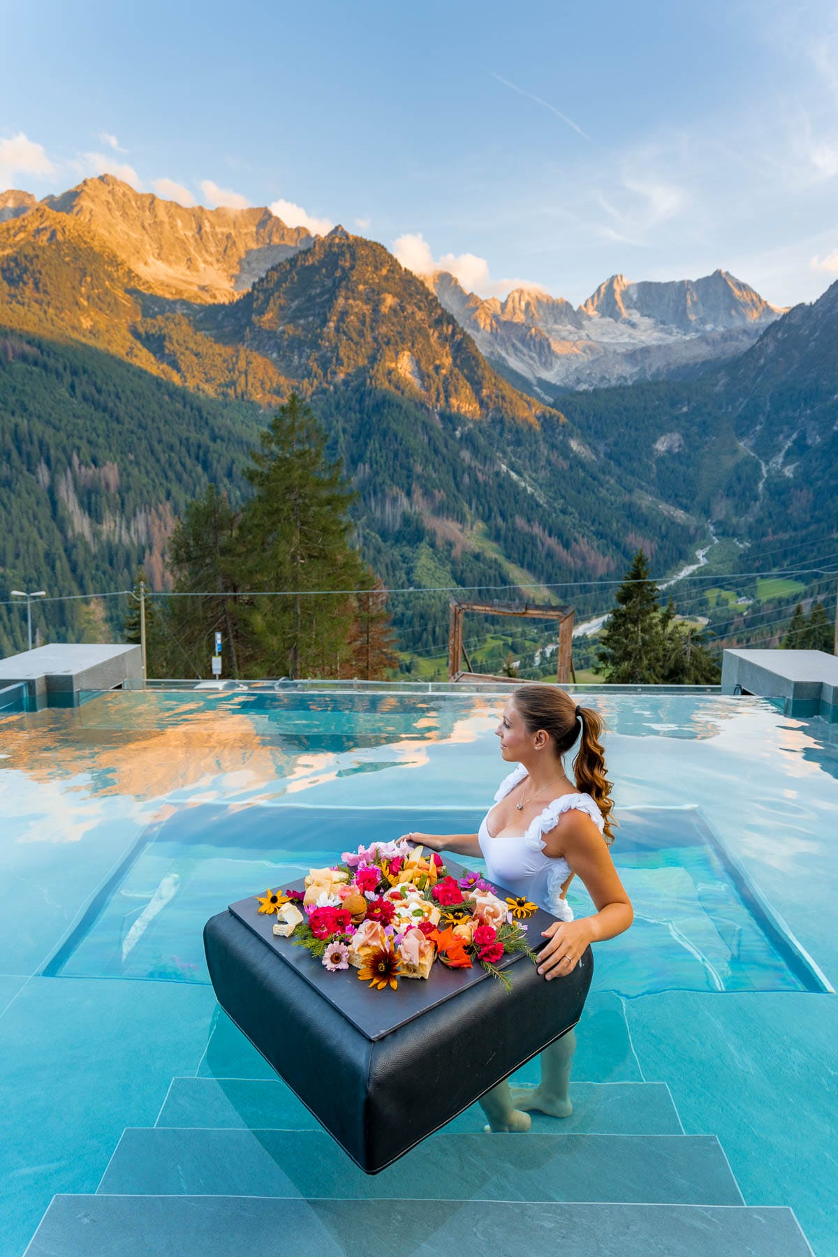 Girl in the infinity pool with floating breakfast at Chalet Al Foss