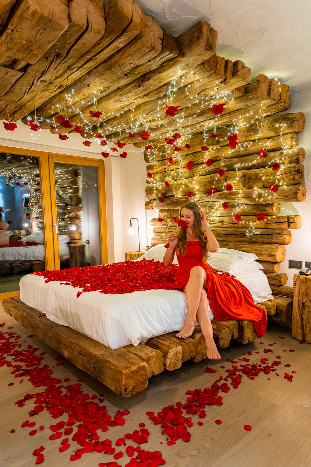 Girl on the bed covered with roses at Chalet Al Foss