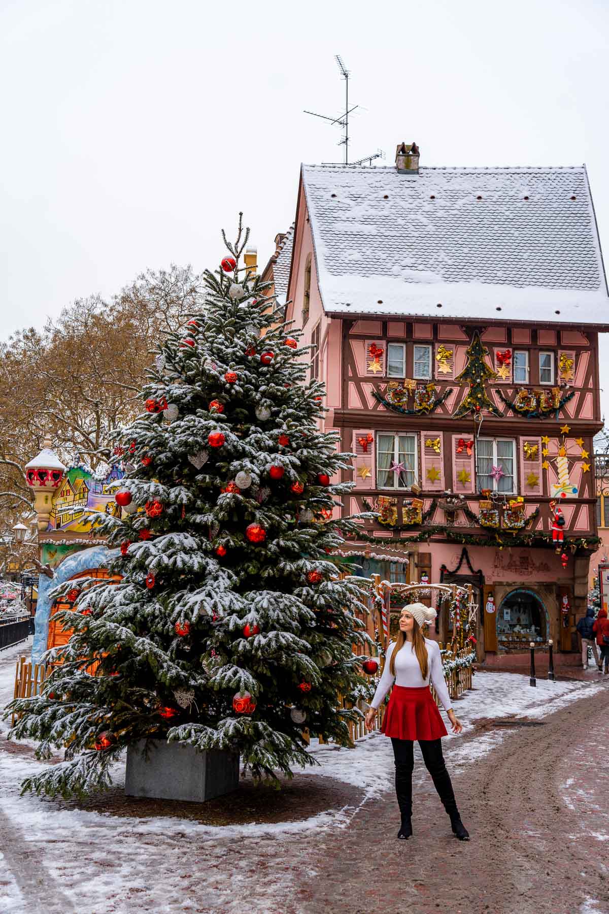 Girl in front of Maison dite in Colmar, France