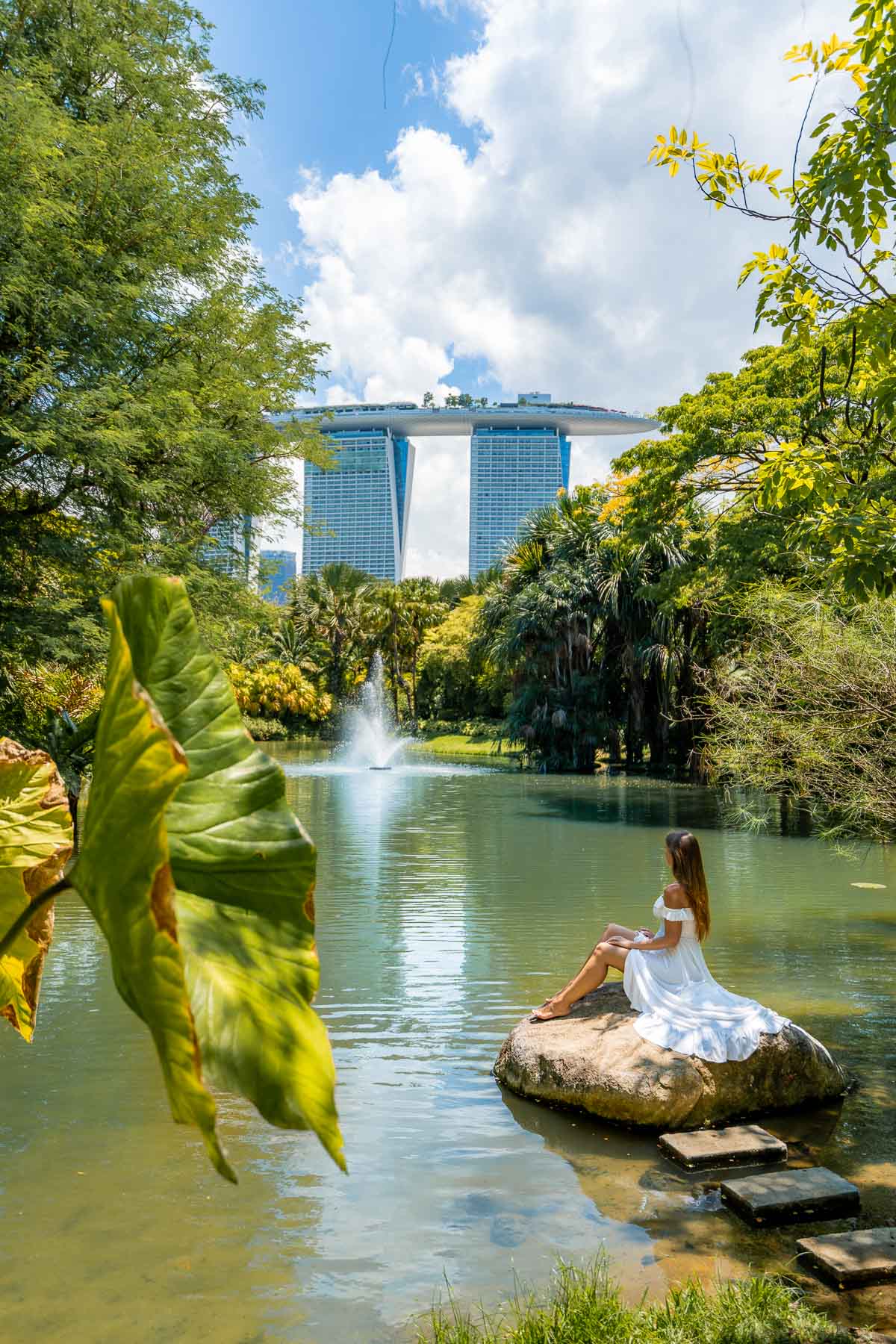 Girl sitting on a rock at Water Lily Pond, Singapore