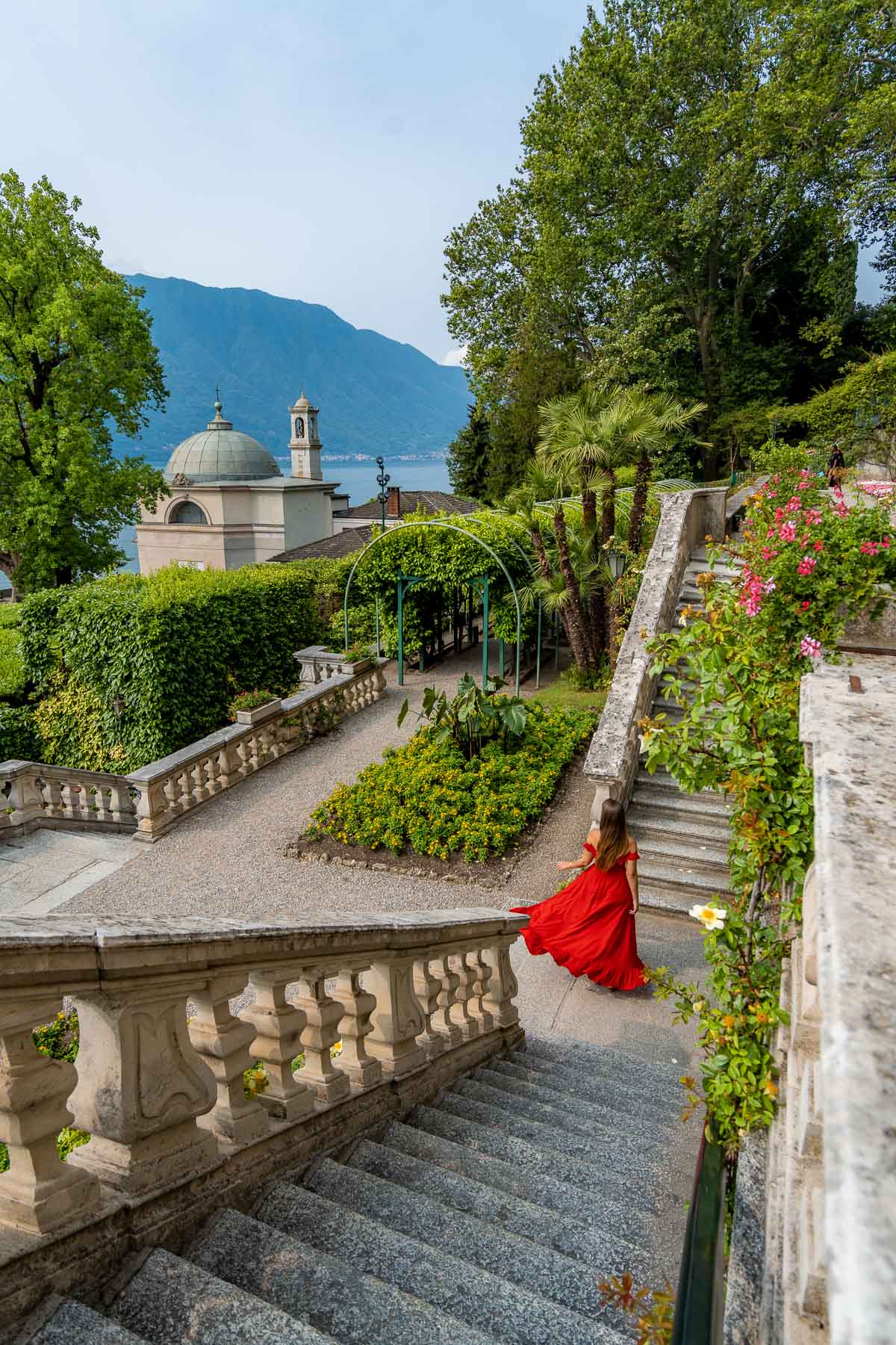 Girl in red dress at the bottom of a staircase at Villa Carlotta, Lake Como