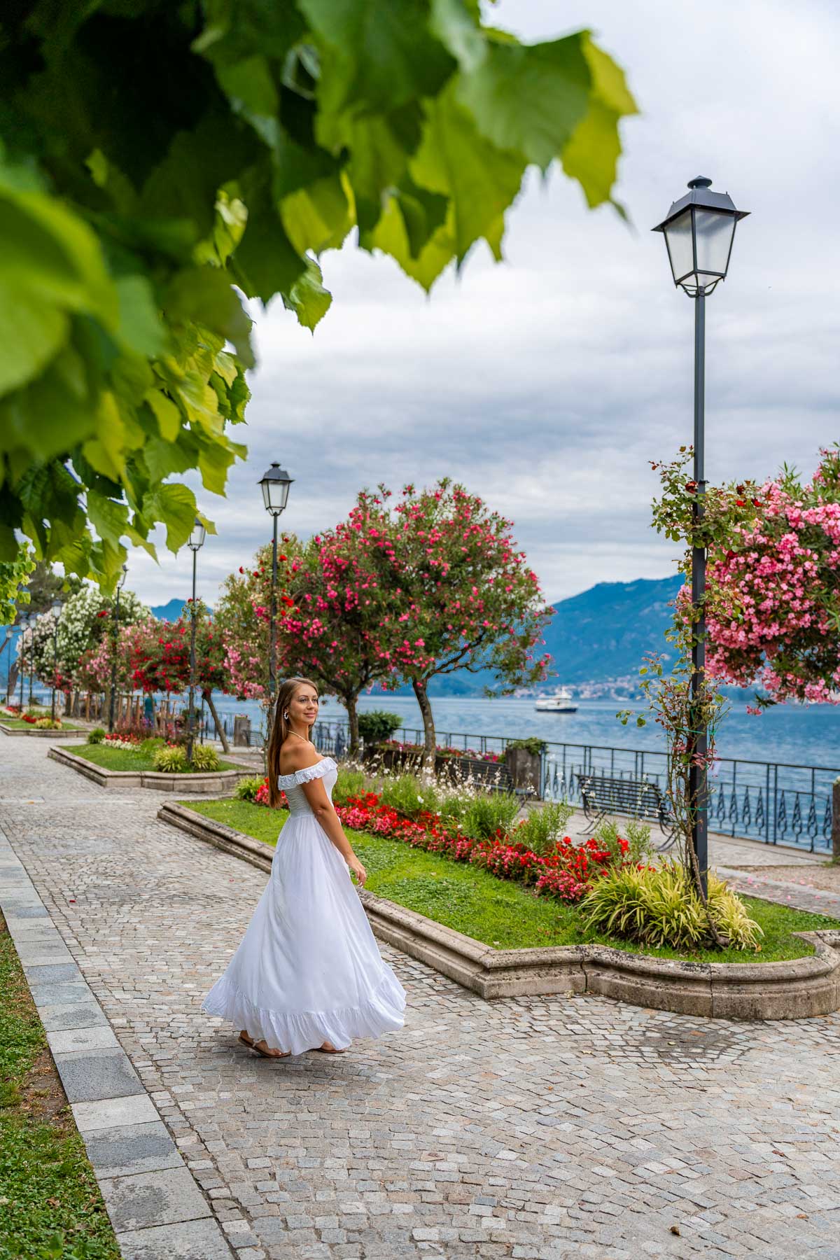 Girl in white dress on the lakefront promenade in Bellagio, Lake Como